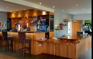 a bar with two bar stools in a restaurant at Turnberry Holiday Park fantastic Seaview in Girvan