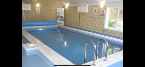 a large swimming pool in a building at Turnberry Holiday Park fantastic Seaview in Girvan