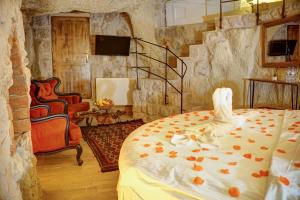 a bedroom with a bed with pumpkins on it at Saliche Cave Suite in Nevşehir