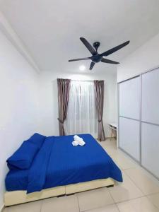 a bedroom with a blue bed and a ceiling fan at Condo @ Bukit Indah/ Legoland/ Eco Botanic 6 pax in Gelang Patah
