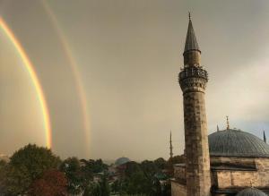 a rainbow over a mosque and a mosque with a minaret at Hotel Sultanahmet in Istanbul