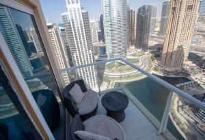 a balcony with a view of a city with tall buildings at Modern & Spacious 2-Bed Condo with Panoramic Lake Views, Dual Balconies, Steps from Dubai JLT Metro By "La Buena Vida Holiday Homes" in Dubai