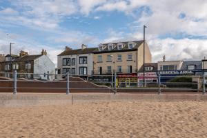 a town with buildings and a beach in front at The Croston balcony apartment- located on the central promenade, beach front and sea views in Morecambe