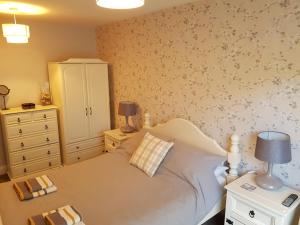 a bedroom with a bed and a dresser at Bancroft Apartment in Durham