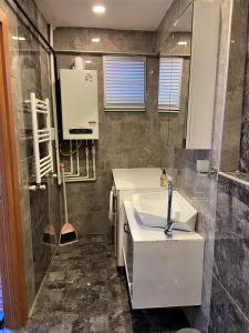 a bathroom with a sink and a shower at Ninve Apartments – Istanbul Bakirköy in Istanbul