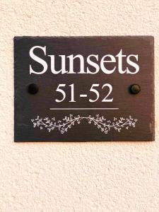 a sign on a wall that reads at Sunsets, Sandylands Prom Morecambe in Morecambe