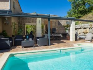 a swimming pool with a pergola next to a house at Impasse des Faysses in Ruoms