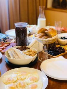 a wooden table with plates of food on it at GRAF Kazbegi in Stepantsminda