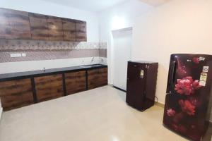 a room with a refrigerator in the corner of a room at Siolim 6bhk Private Villa with Private Pool close to Anjuna Vagator in Siolim