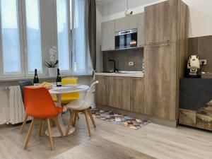 a kitchen with a table and chairs in a room at Ripa150 - Smart Apartament Milano in Milan