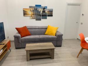 a living room with a couch and a coffee table at Ripa150 - Smart Apartament Milano in Milan