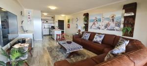 a living room with a couch and a table at Bondi Beach B in Shelly Beach