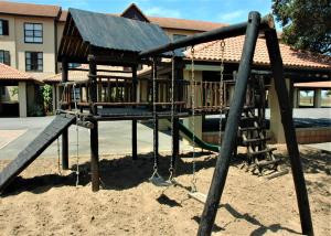 a playground in the sand in front of a building at Bondi Beach B in Shelly Beach