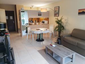 a living room with a couch and a table at Appartement standing front de mer Arcachon in Arcachon