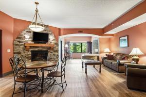 a living room with a table and a fireplace at Chula Vista Condo Unit #2323 in Wisconsin Dells