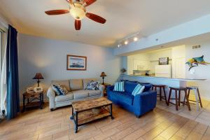 a living room with a couch and a table at Shores of Panama 1615 in Panama City Beach