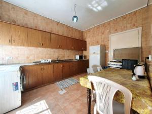 a kitchen with a table and a refrigerator at Lovely Two Bedroom Apartment in Amman in Umm Uthainah
