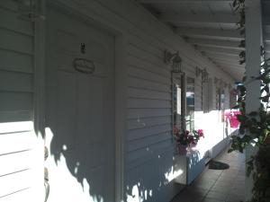 a porch of a house with a white door at El Rancho Motel in San Diego