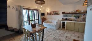 a kitchen and living room with a table and a couch at Le Rapacciole in Spoleto