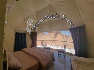 a bedroom with a tent with a view of the desert at Moon Magic Valley in Wadi Rum