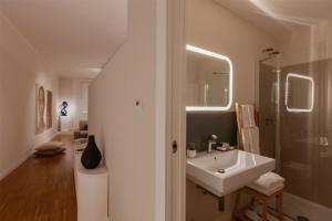 a white bathroom with a sink and a shower at Cobalto Suite in Campobasso