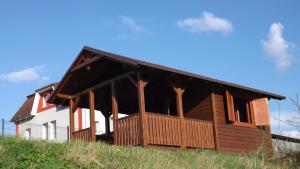 a house on top of a grassy hill at Guest House Penzión Fortuna in Tvrdošín