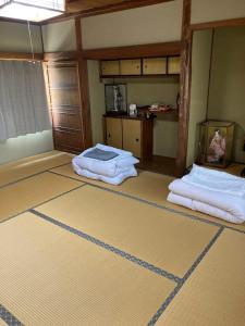 a room with two beds in the middle of a room at Guest house my home 