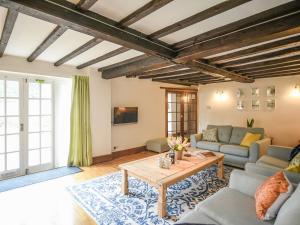 a living room with a couch and a table at Home Farm House in Dorrington