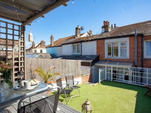 a large backyard with a patio with a lawn at Coastal Haven in Dawlish
