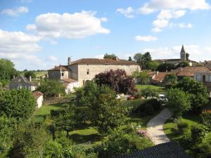 a view of a village with trees and buildings at Chambre Renaissance au Château de Champagne-Mouton in Champagne-Mouton