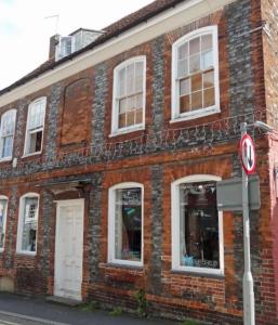 a red brick building with white windows on a street at Segais Accommodation in Grove