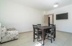 a dining room with a table and chairs and a couch at Beautiful Home In Farindola With 2 Bedrooms in Farindola