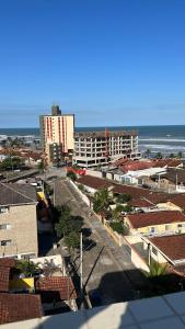 a view of a city with buildings and the ocean at Residencial Michelângelo in Mongaguá