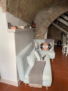 a living room with two white couches and a table at CASA CELOMMI in Montepagano