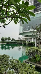 a building with a pond in front of a building at Woodsbury Suites IKEA House Butterworth Penang in Butterworth