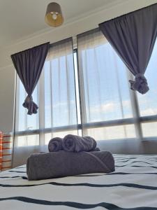 バターワースにあるWoodsbury Suites IKEA House Butterworth Penangの窓付きのベッド(タオル2枚付)
