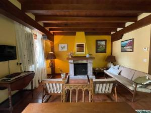 a living room with a couch and a fireplace at Casa El Montero in Espinama