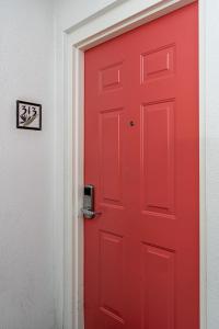 a red door next to a white wall at Harbour House at the Inn 313 in Fort Myers Beach