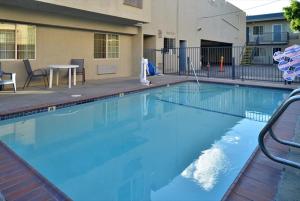 a large blue swimming pool in front of a building at Americas Best Value Inn Hollywood in Los Angeles