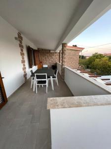 a balcony of a house with a table and chairs at Casa Miele in Santa Lucia