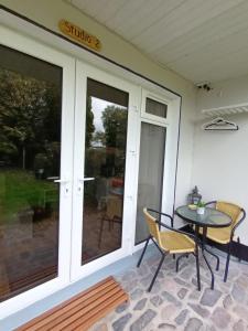 a patio with a table and chairs and a window at Kate's Place bedroom ensuite close to Donegal town in Murlas Bridge