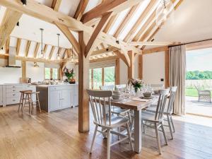 a kitchen and dining room with a table and chairs at Lovington Barn in Ovington