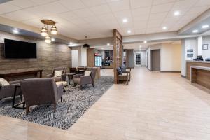 a lobby of a hospital with chairs and a tv at Candlewood Suites Grand Junction, an IHG Hotel in Grand Junction