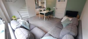 een woonkamer met een bank en een tafel bij Duinhuis26 in Egmond aan Zee