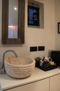 a bathroom counter with a sink with a basket at AuxiliumWellness Get Back to Serenity in Grobbendonk