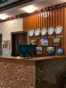 a room with clocks on the wall and a counter at DAVAN in Koshkurgan