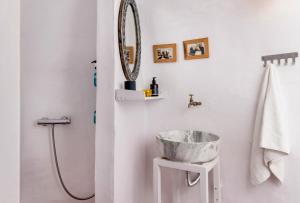 a bathroom with a sink and a mirror at Traditional Farmers Caves in Emporio