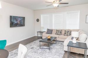 a living room with a couch and a table at New spacious 3 bedroom suite garage parking free Wi-Fi office space and patio view in Duluth