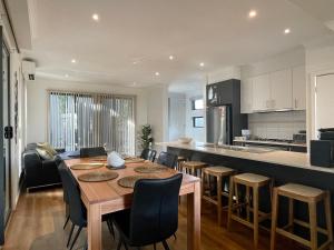 a kitchen and dining room with a table and chairs at Bliss on the Bay Cheerful townhouse in Torquay in Torquay