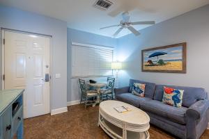 a living room with a couch and a table at Harbour House at the Inn 315 in Fort Myers Beach